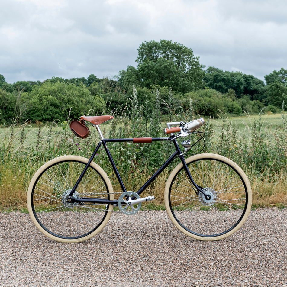 Pashley Guv'nor GT parked on a gravel track with greenery behind