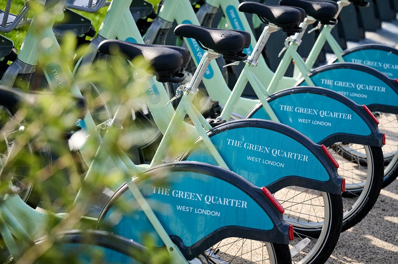 A row of pale green bike share hire bikes 